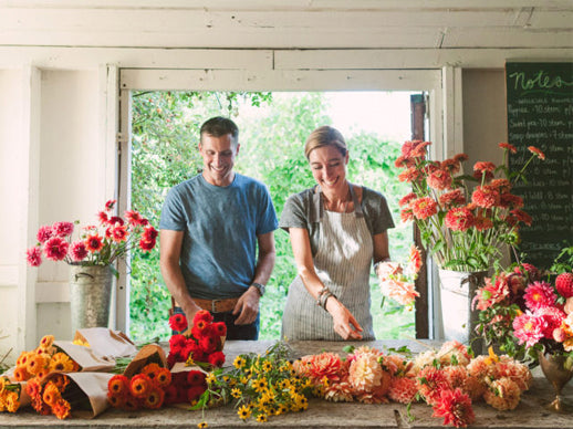 Chris and Erin Benzakein smile while making flower bouquets in the Floret studio