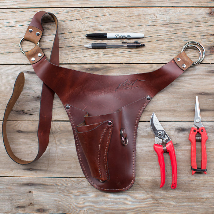 An overhead of Floret’s rosewood righrt-handed tool belt, pens, snips, pruners